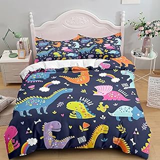 Salto de cama almohadas y edredón con coloridos dinosaurios de dibujos